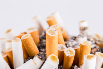 cigarette in ashtray on white background