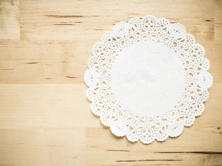 Lace paper on wooden table - obrazy, fototapety, plakaty