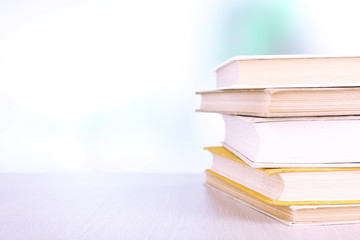 Books on wooden table on natural background