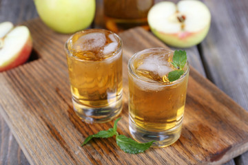 Still life with tasty apple cider in barrel and fresh apples