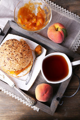 light breakfast with cup of tea and homemade jam on wooden