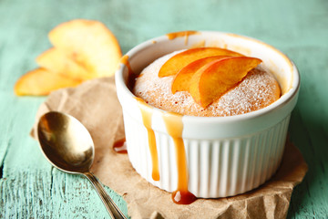 Tasty mini cake with fresh peach, on wooden table