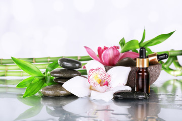 Spa stones, orchids, bamboo branches and aroma oil