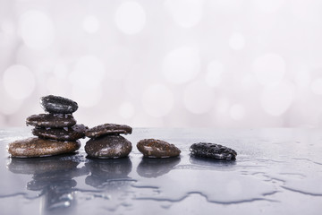 Spa stones in water on table on light background
