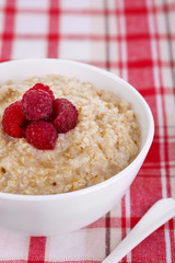 Tasty oatmeal with berries on napkin close-up