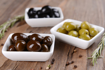 Different marinated olives on table close-up