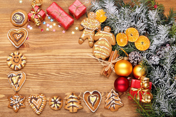 Wooden background with Christmas decorations of gingerbread cook