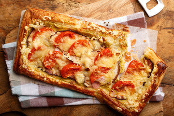 Tasty square pie with tomatoes,bakon and cheese