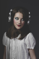 Relax, young girl listening music with huge headphones