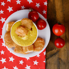 Chicken nuggets with sauce on table close-up