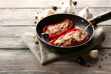 Delicious stuffed peppers in frying pan on table close-up