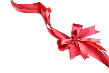 Shiny red ribbon with bow isolated on white