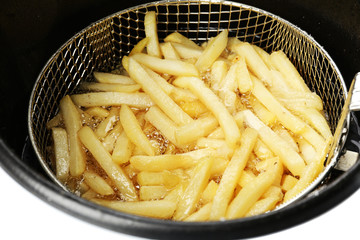 French fries in deep fryer, closeup