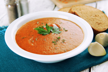 Delicious lentil cream-soup on table close-up