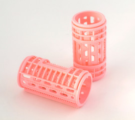 Pink hair curlers isolated on white background