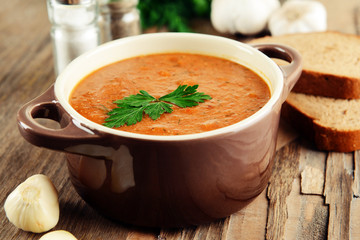 Delicious lentil cream-soup on table close-up