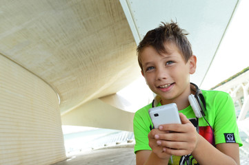 Teen boy with headphones and smartphone