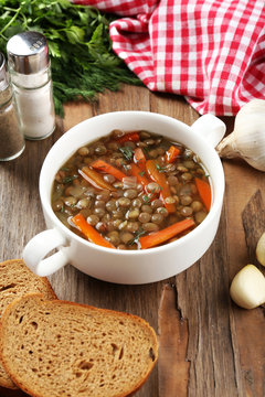 Delicious lentil soup on table close-up