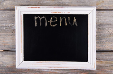 Inscription menu on chalkboard on table close-up