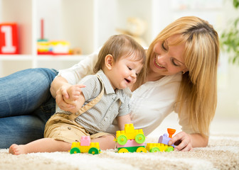 mom and her son playing block toys at home
