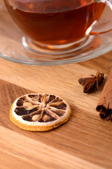 hot tea with lemon and cinnamon on wooden backgroubd