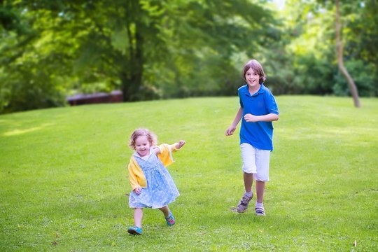 Happy Kids Running In A Park