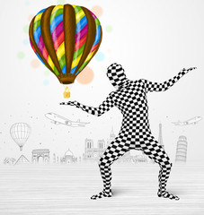 man in full body suit holding balloon