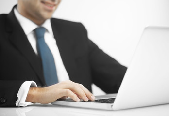 man pushing keys of notebook