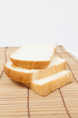 Sliced ​​bread on the wooden plate.