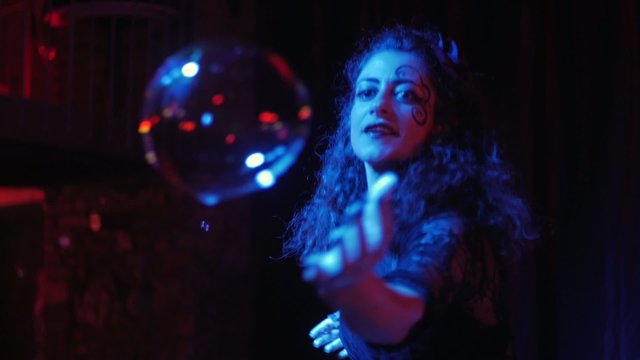 female performer in soap bubbles magician show