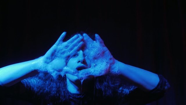 female performer in soap bubbles magician show