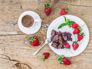 A piece of chocolate strawberry cake with fresh strawberries and