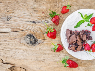 Chocolate strawberry cake with fresh strawberries on a kitchen t