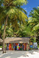 Beach with covered with a thatched roof hut with souvenirs - 71792716