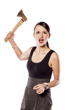 furious young woman swinging an ax