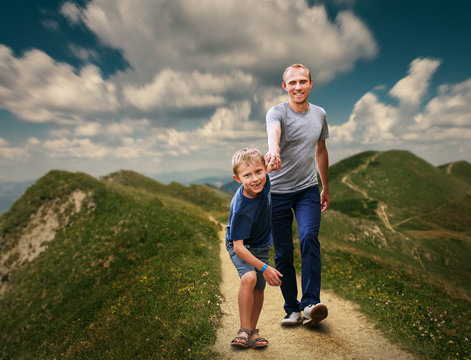 Father  and Son walking on the highmountain footpath;