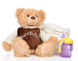 Child stack of diapers and baby feeding bottle with water