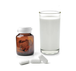 Glass of water Medicine bottle and pills isolated on white backg