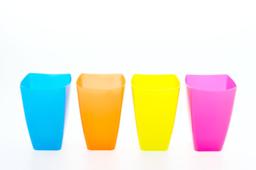 Colorful plastic glass isolated on white background