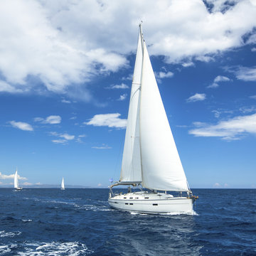 Fototapeta Beautiful sailboat on the open sea. Luxury cruise yacht.