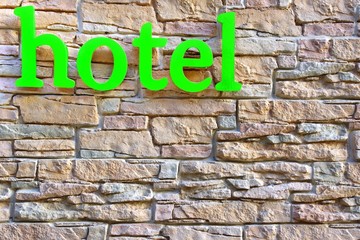 Hotel Sign on Stone Tiled Wall