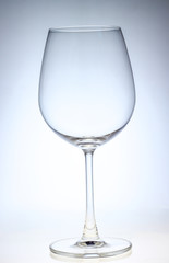 A full  wine glass of water on a neutral background