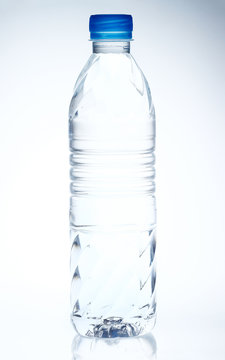 Plastic bottle of drinking water on white