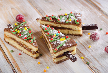 Christmas tree made of  cake on a wooden table .