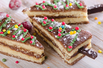 Christmas tree made of  cake on  a wooden background .