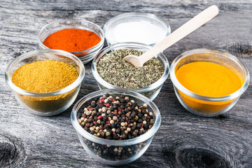 Cooking ingredients, spices, herds on a wooden kitchen table