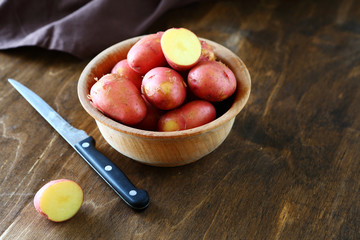 red baby potatoes in a bowl and knife