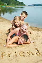 Fototapeta premium Children laying on the beach