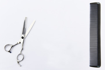 Scissors and comb isolated on white background