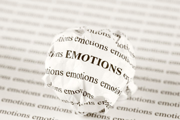 Crumpled paper ball with words emotions